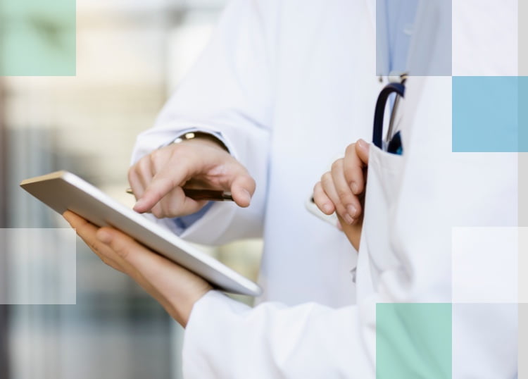 Two eye care professionals discussing the treatment plan for a patient on a tablet.