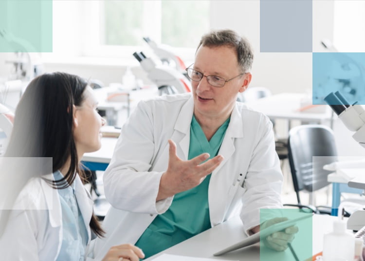 Two eye care professionals discussing the technology behind Bausch + Lomb contact lenses.