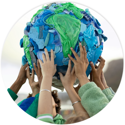 Many hands working together to hold up an Earth shape made of recyclable plastics.